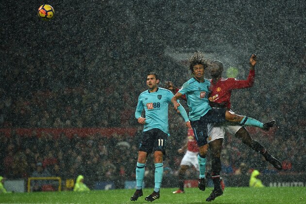 Manchester United's Belgian striker Romelu Lukaku (R) heads the ball past Bournemouth's Dutch defender Nathan Ake to score during the English Premier League football match between Manchester United and Bournemouth at Old Trafford in Manchester, north west England, on December 13, 2017. / AFP PHOTO / Oli SCARFF / RESTRICTED TO EDITORIAL USE. No use with unauthorized audio, video, data, fixture lists, club/league logos or 'live' services. Online in-match use limited to 75 images, no video emulation. No use in betting, games or single club/league/player publications.  /         (Photo credit should read OLI SCARFF/AFP/Getty Images)