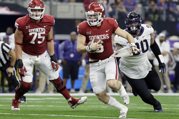Oklahoma offensive lineman Dru Samia (75) watches as quarterback Baker Mayfield, front, is chased out of the pocket by TCU defensive tackle Ross Blacklock, right, in the second half of the Big 12 Conference championship NCAA college football game, Saturday, Dec. 2, 2017, in Arlington, Texas. (AP Photo/Tony Gutierrez)