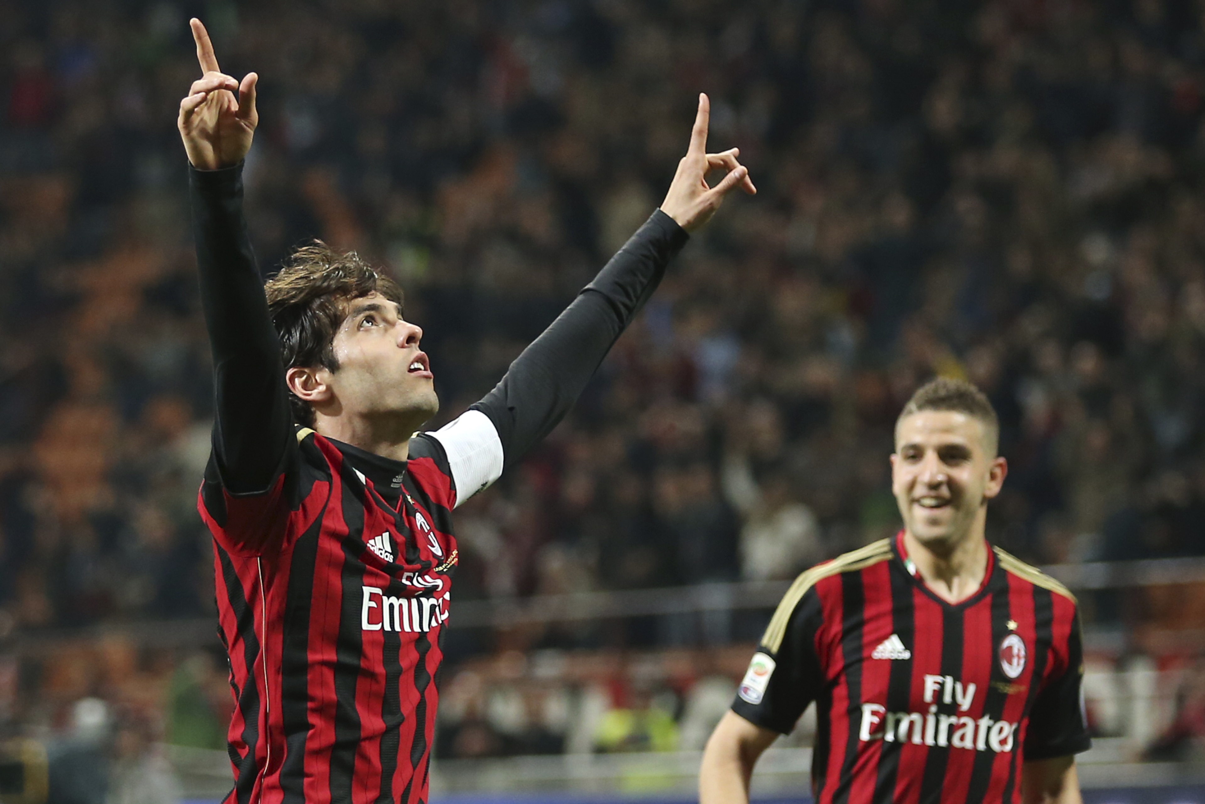 AC Milan Brazilian forward Kaka, left, celebrates with his teammate forward Adel Taarabt, of Morocco, after scoring during the Serie A soccer match between AC Milan and Chievo Verona at the San Siro stadium in Milan, Italy, Saturday, March 29, 2014. (AP Photo/Antonio Calanni)