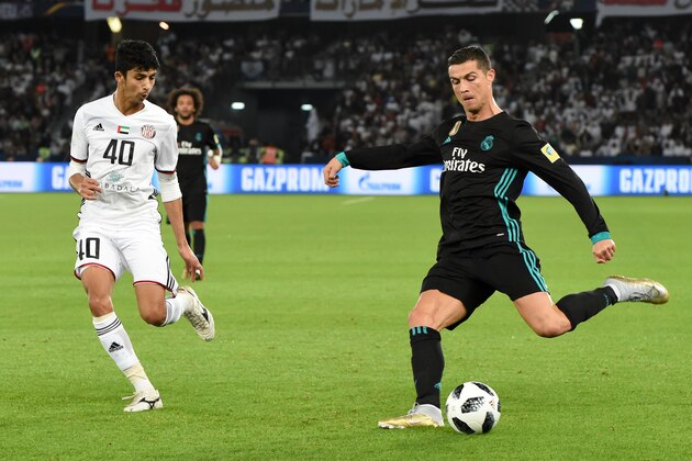 ABU DHABI, UNITED ARAB EMIRATES - DECEMBER 13:  Cristiano Ronaldo (R) of Real Madrid and Mohamad Al Attas of Al Jazira compete for the ball during the FIFA Club World Cup UAE 2017 semi-final match between Al Jazira and Real Madrid  on December 13, 2017 in Abu Dhabi, United Arab Emirates.  (Photo by Etsuo Hara/Getty Images)