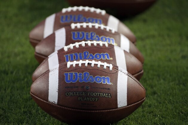 Wilson footballs are lined up on the field before an NCAA college football game between Auburn and Texas A&M Saturday, Nov. 7, 2015, in College Station, Texas. (AP Photo/David J. Phillip)