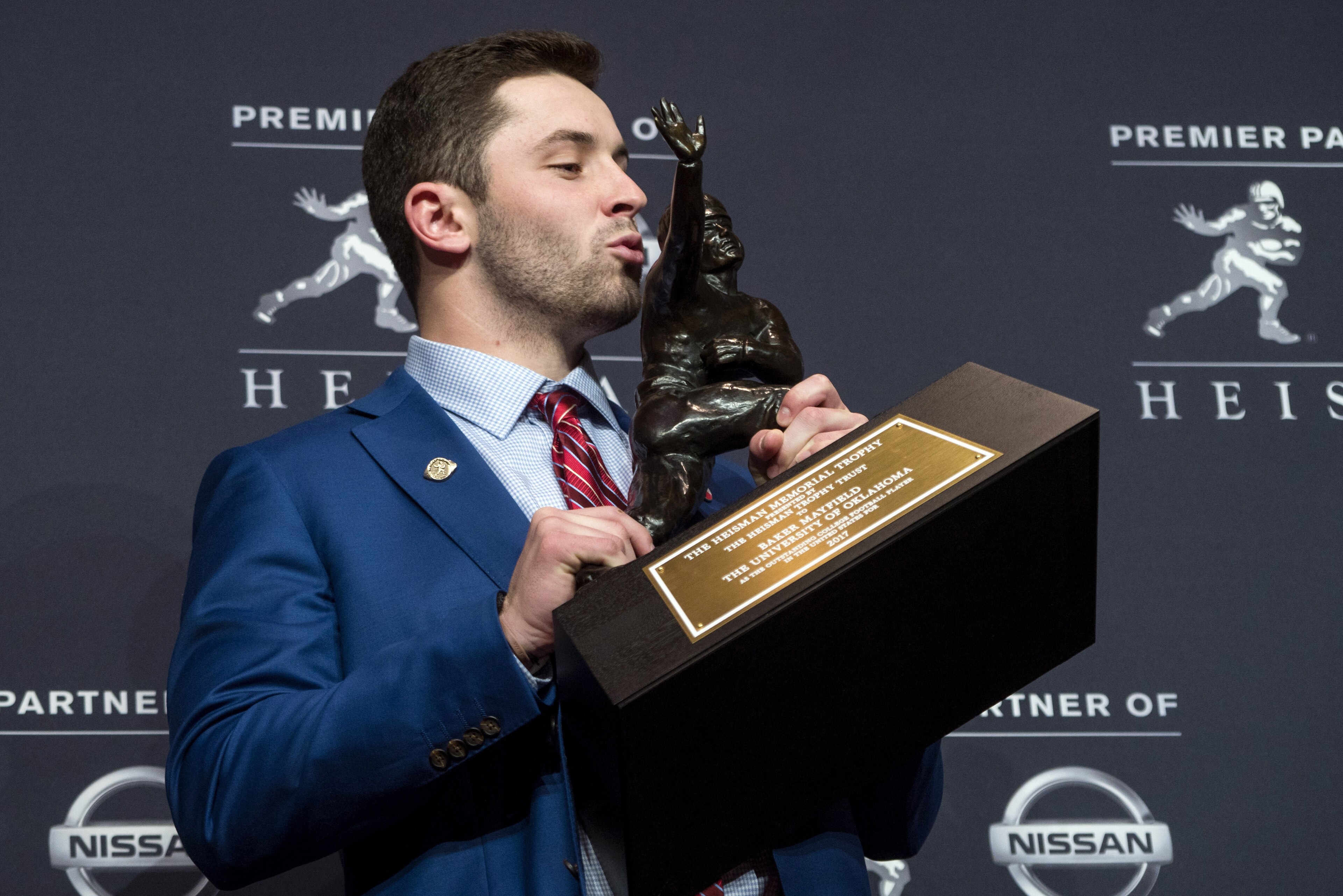 Oklahoma quarterback Baker Mayfield, winner of the Heisman Trophy, poses with the trophy Saturday, Dec. 9, 2017, in New York. (AP Photo/Craig Ruttle)
