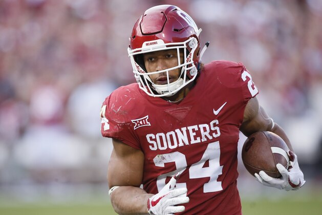 Oklahoma running back Rodney Anderson (24) carries in the second quarter of an NCAA college football game against West Virginia in Norman, Okla., Saturday, Nov. 25, 2017. (AP Photo/Sue Ogrocki)