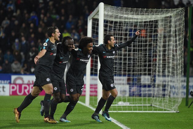 Chelsea's Spanish midfielder Pedro (R) celebrates with teammates after scoring their third goal during the English Premier League football match between Huddersfield Town and Chelsea at the John Smith's stadium in Huddersfield, northern England on December 12, 2017. / AFP PHOTO / Oli SCARFF / RESTRICTED TO EDITORIAL USE. No use with unauthorized audio, video, data, fixture lists, club/league logos or 'live' services. Online in-match use limited to 75 images, no video emulation. No use in betting, games or single club/league/player publications.  /         (Photo credit should read OLI SCARFF/AFP/Getty Images)