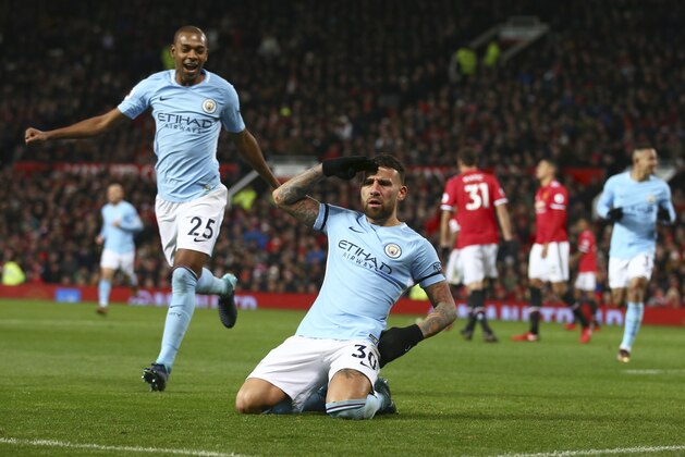 Manchester City's Nicolas Otamendi, center, celebrates after scoring his side's second goal during the English Premier League soccer match between Manchester United and Manchester City at Old Trafford Stadium in Manchester, England, Sunday, Dec. 10, 2017. (AP Photo/Dave Thompson)