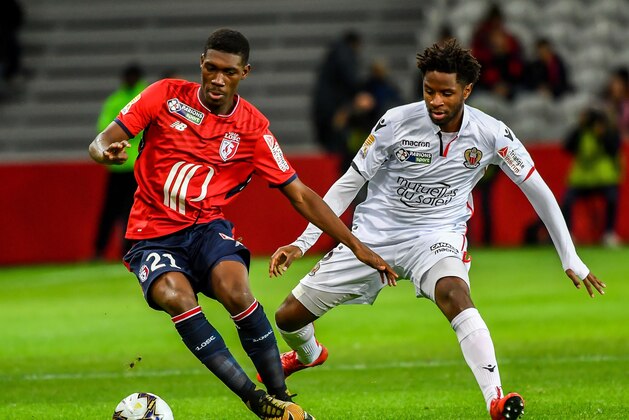 Lille's Malian forward Yves Bissouma (L) fights for the ball with Nice's Ivorian midfielder Jean Michael Seri during the French League Cup round of 16 football match between Lille vs Nice at the ' Pierre Mauroy ' Stadium in Villeneuve d'Ascq northern france on December 13 2017. / AFP PHOTO / PHILIPPE HUGUEN        (Photo credit should read PHILIPPE HUGUEN/AFP/Getty Images)