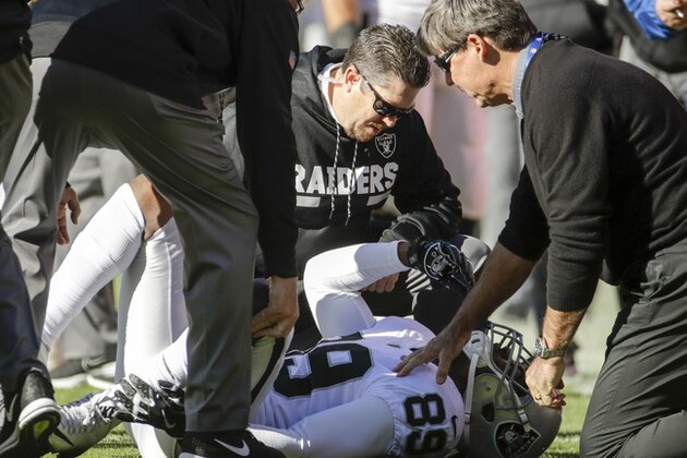 Oakland Raiders trainers look over Oakland Raiders wide receiver Amari Cooper (89) during the first half of an NFL football game against the Kansas City Chiefs in Kansas City, Mo., Sunday, Dec. 10, 2017. (AP Photo/Charlie Riedel)