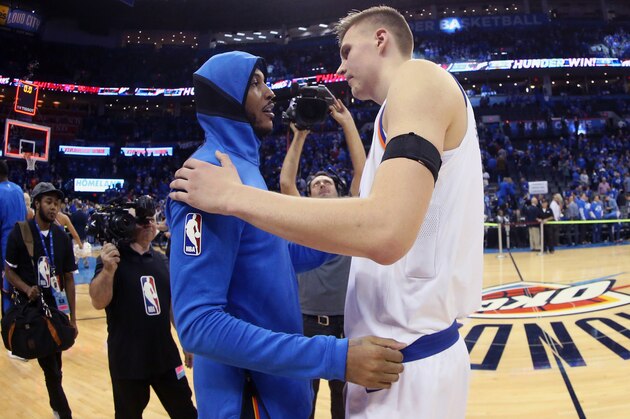OKLAHOMA CITY, OK- OCTOBER 19:  Carmelo Anthony #7 of the Oklahoma City Thunder and Kristaps Porzingis #6 of the New York Knicks hug after the game on October 19, 2017 at Chesapeake Energy Arena in Oklahoma City, Oklahoma. NOTE TO USER: User expressly acknowledges and agrees that, by downloading and or using this photograph, User is consenting to the terms and conditions of the Getty Images License Agreement. Mandatory Copyright Notice: Copyright 2017 NBAE (Photo by Layne Murdoch Sr./NBAE via Getty Images)