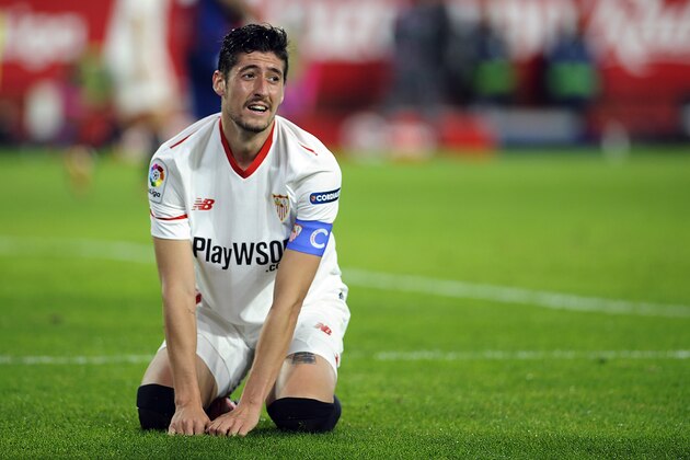 Sevilla's defender Sergio Escudero kneels on the field during the Spanish league football match Sevilla FC vs Levante at the Ramon Sanchez Pizjuan stadium in Sevilla on December 15, 2017. / AFP PHOTO / Cristina Quicler        (Photo credit should read CRISTINA QUICLER/AFP/Getty Images)