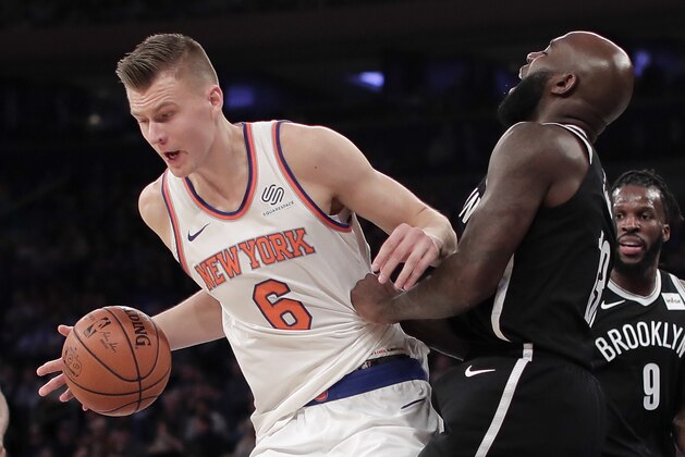 New York Knicks forward Kristaps Porzingis (6) drives the lane against Brooklyn Nets forward Quincy Acy (13) during the second quarter of an NBA basketball game, Friday, Oct. 27, 2017, in New York. (AP Photo/Julie Jacobson)