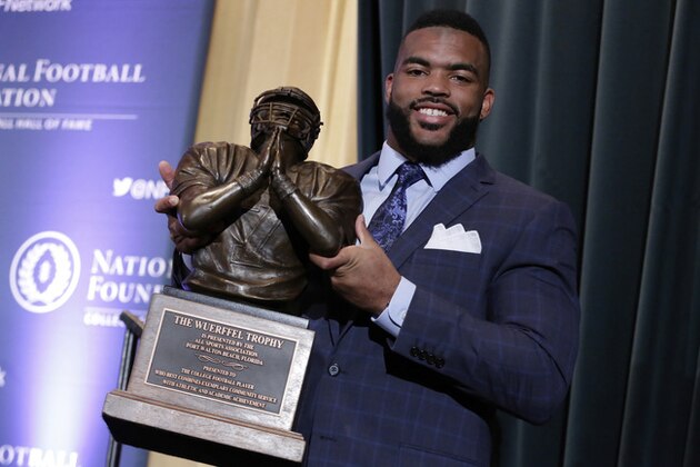 University of Kentucky football linebacker Courtney Love holds his Wuerrfel Trophy, given for community service, during a news conference of the National Football Foundation College Football Hall of Fame, in New York, Tuesday, Dec. 5, 2017. (AP Photo/Richard Drew)