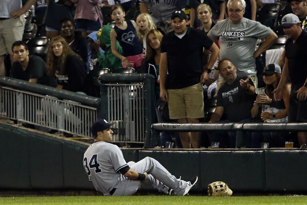 New York Yankees' Dustin Fowler sits on the field after suffering an injury during the first inning of the team's baseball game against the Chicago White Sox on Thursday, June 29, 2017, in Chicago. (AP Photo/Nam Y. Huh)