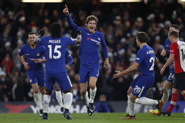 Chelsea's Spanish defender Marcos Alonso (C) celebrates after scoring with Chelsea's Nigerian midfielder Victor Moses (L) and Chelsea's Spanish defender Cesar Azpilicueta during the English Premier League football match between Chelsea and Southampton at Stamford Bridge in London on December 16, 2017. / AFP PHOTO / Adrian DENNIS / RESTRICTED TO EDITORIAL USE. No use with unauthorized audio, video, data, fixture lists, club/league logos or 'live' services. Online in-match use limited to 75 images, no video emulation. No use in betting, games or single club/league/player publications.  /         (Photo credit should read ADRIAN DENNIS/AFP/Getty Images)