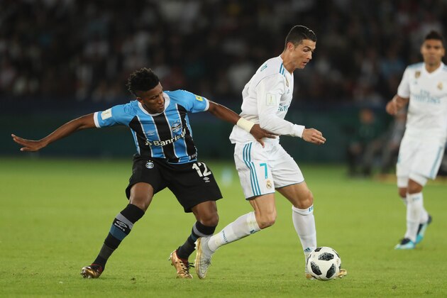 ABU DHABI, UNITED ARAB EMIRATES - DECEMBER 16:  Bruno Cortez of Gremio FBPA competes with Cristiano Ronaldo of Real Madrid during the FIFA Club World Cup UAE 2017 final match between Gremio and Real Madrid CF at Zayed Sports City Stadium on December 16, 2017 in Abu Dhabi, United Arab Emirates. (Photo by Matthew Ashton - AMA/Getty Images)