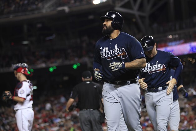 Atlanta Braves' Matt Kemp, center, runs back to their dugout with his teammate Freddie Freeman, right, after hitting a grand slam during the seventh inning of a baseball game against the Washington Nationals in Washington, Wednesday, Sept. 13, 2017. Washington Nationals catcher Matt Wieters stands on the left. (AP Photo/Manuel Balce Ceneta)