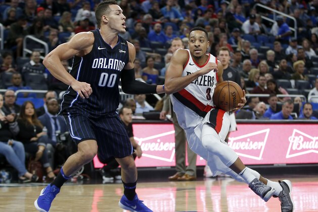Portland Trail Blazers guard CJ McCollum (3) drives around Orlando Magic forward Aaron Gordon (00) during the second half of an NBA basketball game in Orlando, Fla., on Friday, Dec. 15, 2017. The Trail Blazers won 95-88. (AP Photo/Reinhold Matay)