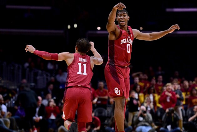 LOS ANGELES, CA - DECEMBER 08: Christian James #0 and Trae Young #11 of the Oklahoma Sooners react to a score in an 85-83 win over the USC Trojans during the Basketball Hall of Fame Classic at Staples Center on December 8, 2017 in Los Angeles, California.  (Photo by Harry How/Getty Images)
