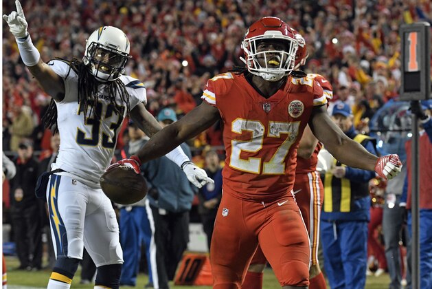 Kansas City Chiefs running back Kareem Hunt (27) celebrates his touchdown in front of Los Angeles Chargers safety Tre Boston (33) during the second half of an NFL football game in Kansas City, Mo., Saturday, Dec. 16, 2017. (AP Photo/Ed Zurga)