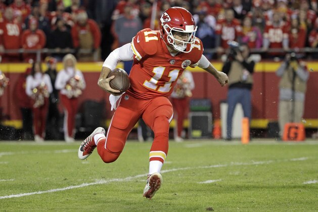 Kansas City Chiefs quarterback Alex Smith (11) carries the ball during the first half of an NFL football game against the Los Angeles Chargers in Kansas City, Mo., Saturday, Dec. 16, 2017. (AP Photo/Charlie Riedel)