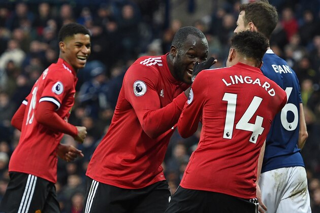 Manchester United's English midfielder Jesse Lingard (R) celebrates with Manchester United's Belgian striker Romelu Lukaku (C) after scoring their second goal during the English Premier League football match between West Bromwich Albion and Manchester United at The Hawthorns stadium in West Bromwich, central England, on December 17, 2017.
 / AFP PHOTO / Oli SCARFF / RESTRICTED TO EDITORIAL USE. No use with unauthorized audio, video, data, fixture lists, club/league logos or 'live' services. Online in-match use limited to 75 images, no video emulation. No use in betting, games or single club/league/player publications.  /         (Photo credit should read OLI SCARFF/AFP/Getty Images)