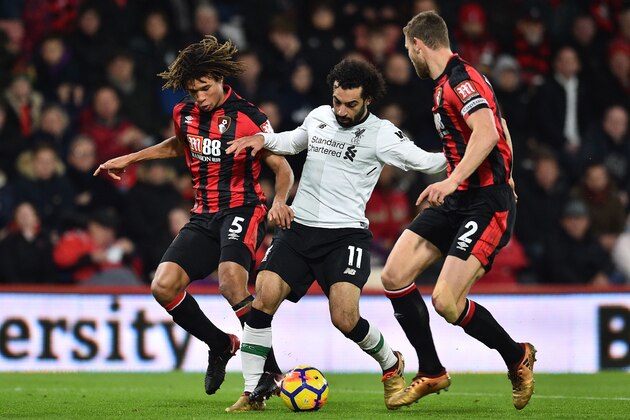 Liverpool's Egyptian midfielder Mohamed Salah (C) vies with Bournemouth's Dutch defender Nathan Ake (L) and Bournemouth's English defender Simon Francis (R) during the English Premier League football match between Bournemouth and Liverpool at the Vitality Stadium in Bournemouth, southern England on December 17, 2017. / AFP PHOTO / Glyn KIRK / RESTRICTED TO EDITORIAL USE. No use with unauthorized audio, video, data, fixture lists, club/league logos or 'live' services. Online in-match use limited to 75 images, no video emulation. No use in betting, games or single club/league/player publications.  /         (Photo credit should read GLYN KIRK/AFP/Getty Images)