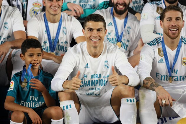 ABU DHABI, UNITED ARAB EMIRATES - DECEMBER 16:  Cristiano Ronaldo of Real Madrid celebrates with his son Cristiano Ronaldo Jnr and his team-mates at the end of the FIFA Club World Cup UAE 2017 final match between Gremio and Real Madrid CF at Zayed Sports City Stadium on December 16, 2017 in Abu Dhabi, United Arab Emirates. (Photo by Matthew Ashton - AMA/Getty Images)