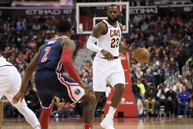 Cleveland Cavaliers forward LeBron James (23) dribbles against Washington Wizards guard John Wall (2) during the first half of an NBA basketball game, Sunday, Dec. 17, 2017, in Washington. (AP Photo/Nick Wass)