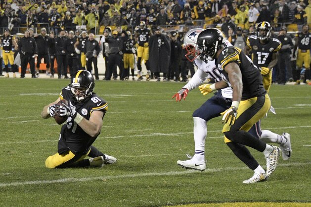 Pittsburgh Steelers tight end Jesse James (81) has a knee down before crossing the goal line with a pass from quarterback Ben Roethlisberger during the second half of an NFL football game against the New England Patriots in Pittsburgh, Sunday, Dec. 17, 2017. (AP Photo/Don Wright)