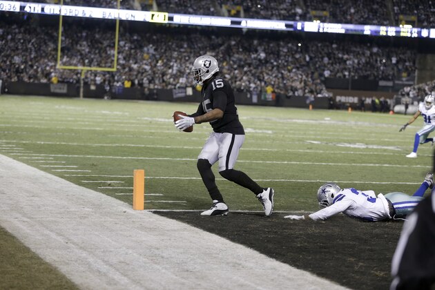 Oakland Raiders wide receiver Michael Crabtree (15) scores a touchdown against the Dallas Cowboys during the second half of an NFL football game in Oakland, Calif., Sunday, Dec. 17, 2017. (AP Photo/Ben Margot)