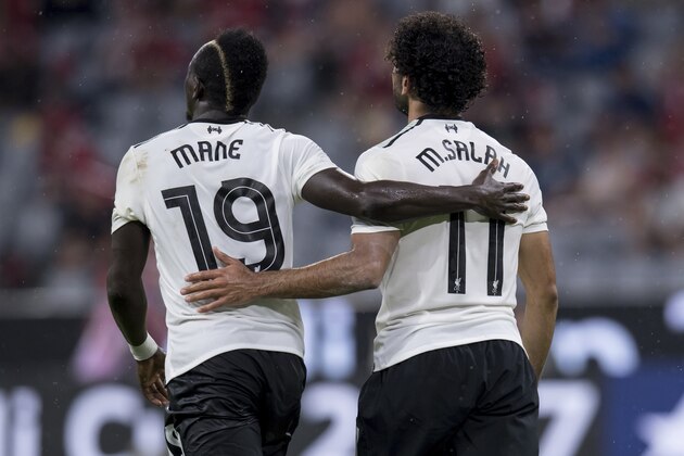 Liverpool's Mohamed Salah, right, celebrates with teammate Sadio Mane after scoring during the Audi Cup semifinal soccer match between FC Bayern Munich and Liverpool FC in the Allianz Arena in Munich, Germany, Tuesday, Aug. 1 2017. (Sven Hoppe/dpa via AP)