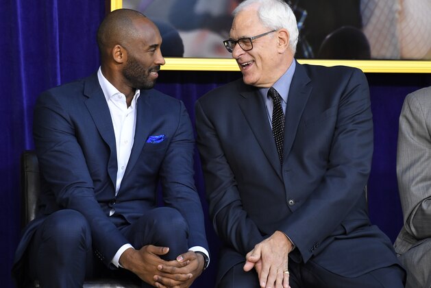 Kobe Bryant, left, and Phil Jackson chat at the unveiling of Shaquille O'Neal's statue in front of Staples Center, Friday, March 24, 2017, in Los Angeles. (AP Photo/Mark J. Terrill)