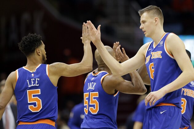 New York Knicks' Kristaps Porzingis (6), from Latvia, and Courtney Lee (5) celebrate in the first half of an NBA basketball game against the Cleveland Cavaliers , Sunday, Oct. 29, 2017, in Cleveland. The Knicks won 114-95. (AP Photo/Tony Dejak)