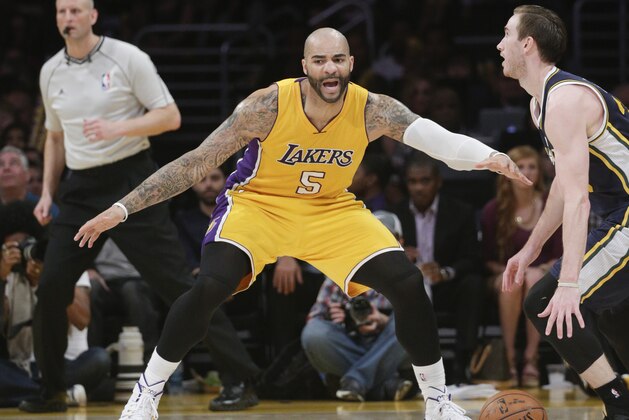 Los Angeles Lakers' Carlos Boozer pressures Utah Jazz's Gordon Hayward during the second half of an NBA basketball game, Thursday, March 19, 2015, in Los Angeles. The Jazz 80-73. (AP Photo/Jae C. Hong)