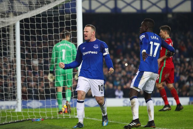 LIVERPOOL, ENGLAND - DECEMBER 18:  Wayne Rooney of Everton celebrates as he scores their third goal from the penalty spot with Idrissa Gueye during the Premier League match between Everton and Swansea City at Goodison Park on December 18, 2017 in Liverpool, England.  (Photo by Clive Brunskill/Getty Images)