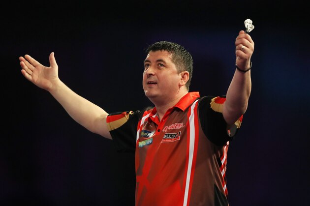 LONDON, ENGLAND - DECEMBER 18: Mensur Suljovic of Austria celebrates after winning his first round match against Kevin Painter of England on day five of the 2018 William Hill PDC World Darts Championships at Alexandra Palace on December 18, 2017 in London, England.  (Photo by Linnea Rheborg/Getty Images)