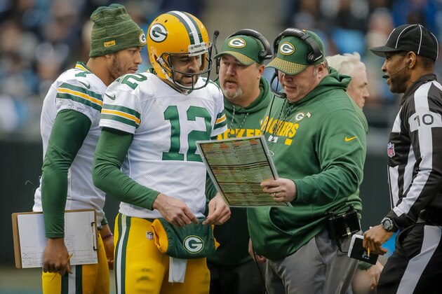 Green Bay Packers' Aaron Rodgers (12) huddles with head coach Mike McCarthy during the second half of an NFL football game against the Carolina Panthers in Charlotte, N.C., Sunday, Dec. 10, 2017. The Panthers won 31-24. (AP Photo/Bob Leverone)