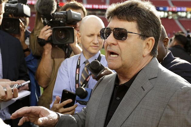 Former San Francisco 49ers owner Eddie DeBartolo Jr., right, speaks to reporters before an NFL football game between the San Francisco 49ers and the Minnesota Vikings in Santa Clara, Calif., Monday, Sept. 14, 2015. (AP Photo/Eric Risberg)