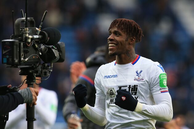 Crystal Palace's Ivorian striker Wilfried Zaha celebrates on the pitch after the English Premier League football match between Leicester City and Crystal Palace at King Power Stadium in Leicester, central England on December 16, 2017.
Crystal Palace won the game 3-0. / AFP PHOTO / Lindsey PARNABY / RESTRICTED TO EDITORIAL USE. No use with unauthorized audio, video, data, fixture lists, club/league logos or 'live' services. Online in-match use limited to 75 images, no video emulation. No use in betting, games or single club/league/player publications.  /         (Photo credit should read LINDSEY PARNABY/AFP/Getty Images)