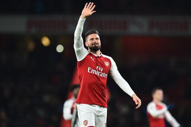 Arsenal's French striker Olivier Giroud waves to supporters after the English Premier League football match between Arsenal and Newcastle United at the Emirates Stadium in London on December 16, 2017. 
Arsenal won the game 1-0. / AFP PHOTO / Glyn KIRK / RESTRICTED TO EDITORIAL USE. No use with unauthorized audio, video, data, fixture lists, club/league logos or 'live' services. Online in-match use limited to 75 images, no video emulation. No use in betting, games or single club/league/player publications.  /         (Photo credit should read GLYN KIRK/AFP/Getty Images)