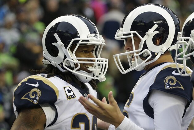 Los Angeles Rams running back Todd Gurley, left, is greeted by quarterback Jared Goff, right, after Gurley scored a touchdown in the second half of an NFL football game against the Seattle Seahawks, Sunday, Dec. 17, 2017, in Seattle. (AP Photo/Elaine Thompson)