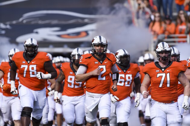 Oklahoma St quarterback Mason Rudolph (2) leads his team onto the field before a NCAA college football game between Kansas and Oklahoma St in Stillwater, Okla., Saturday, Nov. 25, 2017.(AP Photo/Brody Schmidt)