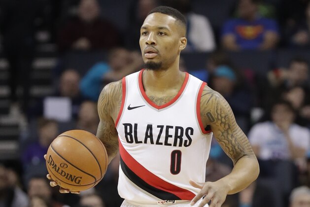 Portland Trail Blazers' Damian Lillard (0) brings the ball up the court against the Charlotte Hornets during the first half of an NBA basketball game in Charlotte, N.C., Saturday, Dec. 16, 2017. (AP Photo/Chuck Burton)