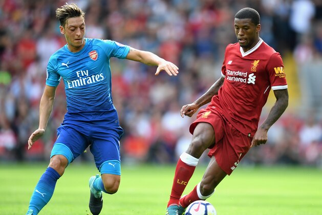 LIVERPOOL, ENGLAND - AUGUST 27:  Mesut Ozil of Arsenal and Georginio Wijnaldum of Liverpool battle for possession during the Premier League match between Liverpool and Arsenal at Anfield on August 27, 2017 in Liverpool, England.  (Photo by Michael Regan/Getty Images)