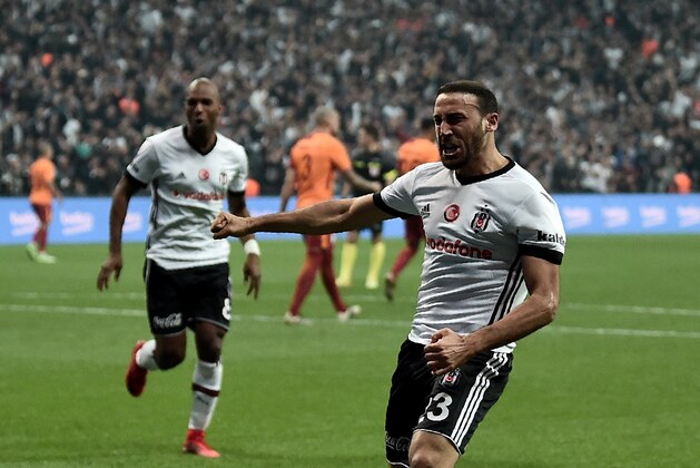 Besiktas' Turkish forward Cenk Tosun celebrates after scoring a goal during the Turkish Super Lig football match between Besiktas and Galatasaray on December 2, 2017 at Vodafone Park Stadium in Istanbul. / AFP PHOTO / OZAN KOSE        (Photo credit should read OZAN KOSE/AFP/Getty Images)