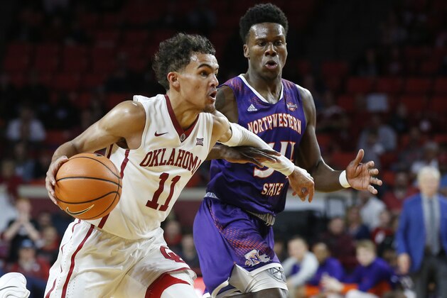 Oklahoma guard Trae Young (11) drives past Northwestern State forward Brandon Hutton, right, in the second half of an NCAA college basketball game in Norman, Okla., Tuesday, Dec. 19, 2017. Oklahoma won 105-68. (AP Photo/Sue Ogrocki)