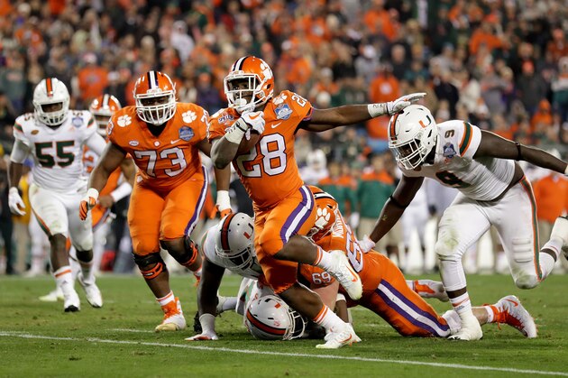 CHARLOTTE, NC - DECEMBER 02:  Tavien Feaster #28 of the Clemson Tigers runs the ball against the Miami Hurricanes in the third quarter during the ACC Football Championship at Bank of America Stadium on December 2, 2017 in Charlotte, North Carolina.  (Photo by Streeter Lecka/Getty Images)