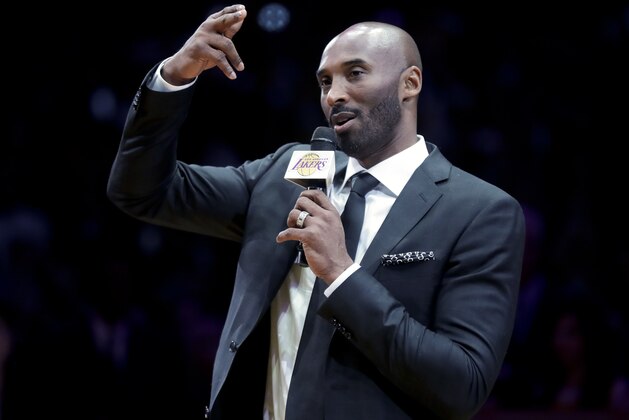 Former Los Angeles Laker Kobe Bryant speaks during a halftime ceremony retiring both of his jersey's during an NBA basketball game between the Los Angeles Lakers and the Golden State Warriors, in Los Angeles, Monday, Dec. 18, 2017. (AP Photo/Chris Carlson)