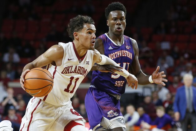 Oklahoma guard Trae Young (11) drives past Northwestern State forward Brandon Hutton, right, in the second half of an NCAA college basketball game in Norman, Okla., Tuesday, Dec. 19, 2017. Oklahoma won 105-68. (AP Photo/Sue Ogrocki)