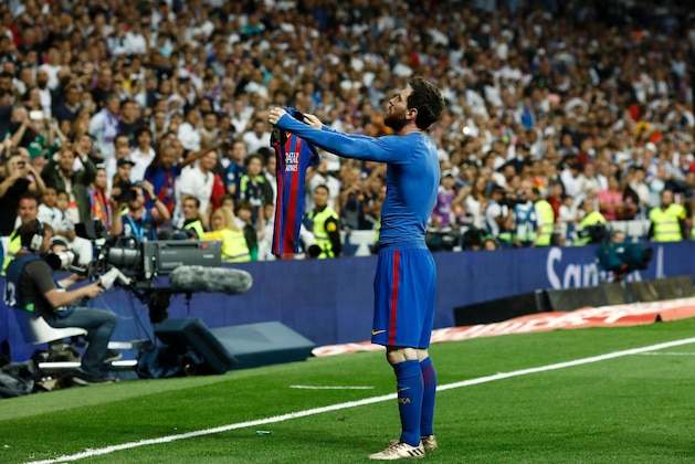 Barcelona's Argentinian forward Lionel Messi celebrates after scoring during the Spanish league Clasico football match Real Madrid CF vs FC Barcelona at the Santiago Bernabeu stadium in Madrid on April 23, 2017. / AFP PHOTO / OSCAR DEL POZO        (Photo credit should read OSCAR DEL POZO/AFP/Getty Images)