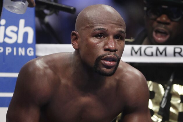 Floyd Mayweather Jr. rests in his corner between rounds in a super welterweight boxing match against Conor McGregor, Saturday, Aug. 26, 2017, in Las Vegas. (AP Photo/Isaac Brekken)
